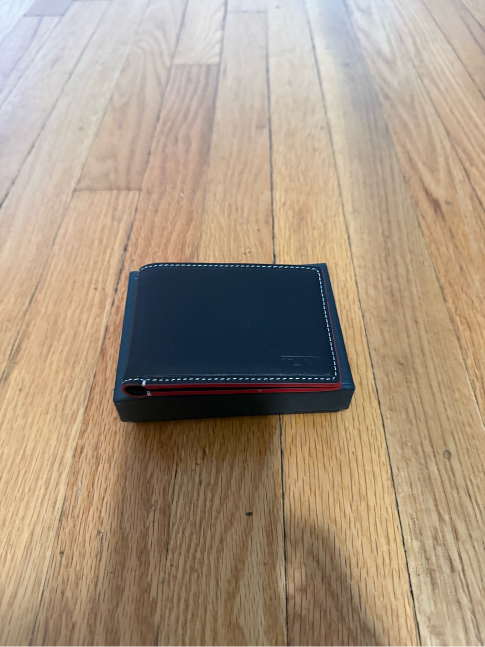 Tumi Black Leather Bifold Wallet with Red Edge